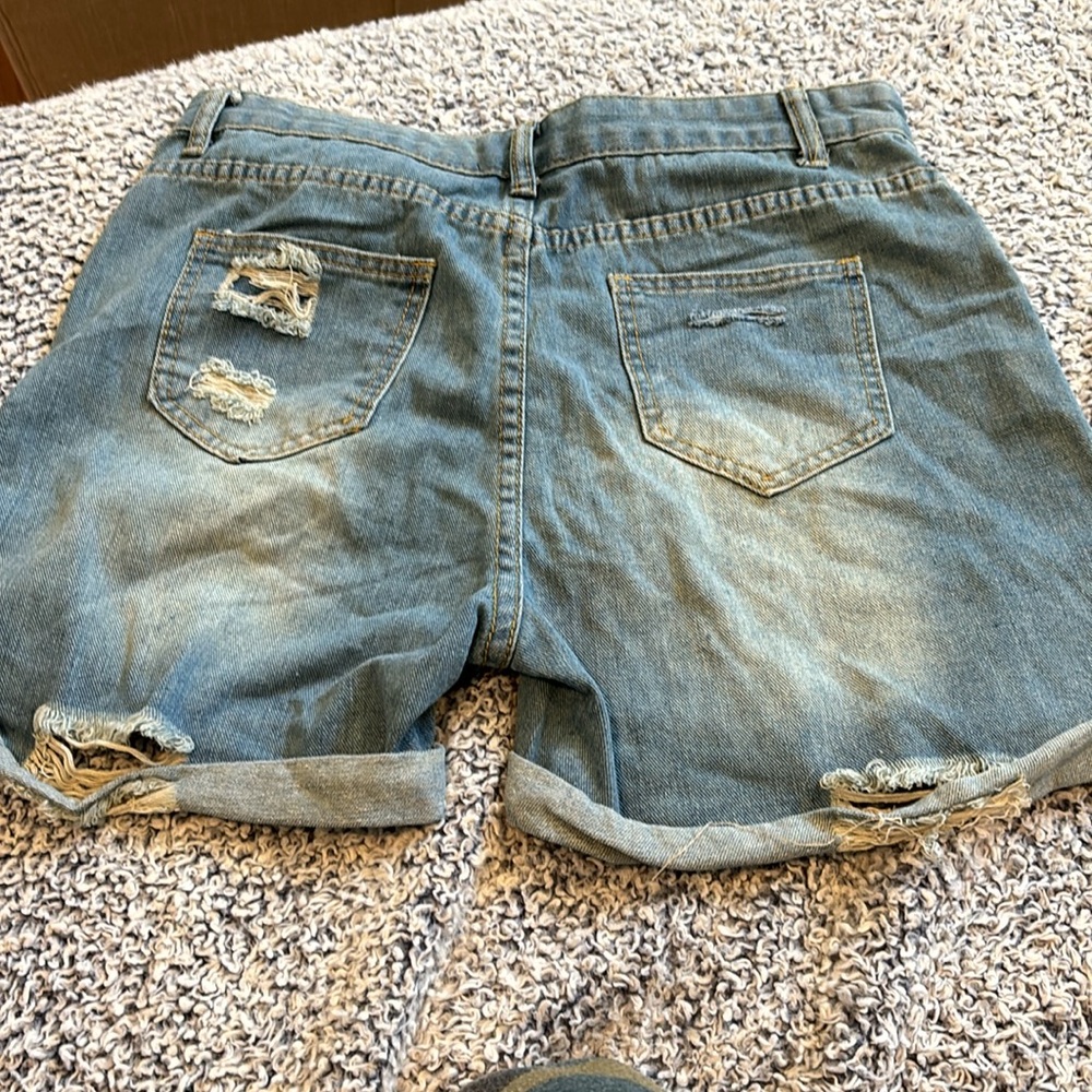 Large light blue soft denim cuffed jean shorts with shredded holes. - Picture 3 of 4